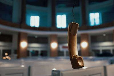 Close-up of telephone in illuminated room