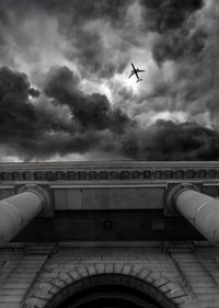 Low angle view of train against cloudy sky