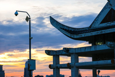 Low angle view of street light against sky at sunset