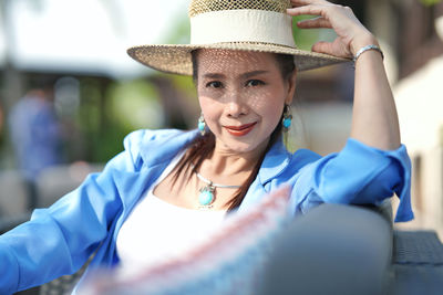 Portrait of smiling young woman wearing hat