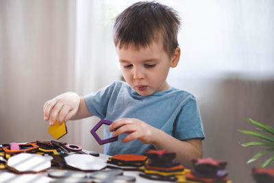 Portrait of cute girl playing with toy on table