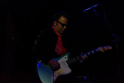 Man playing guitar at night