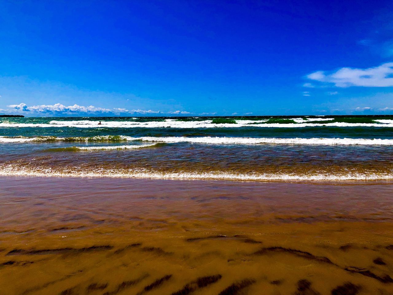 VIEW OF BEACH AGAINST BLUE SKY