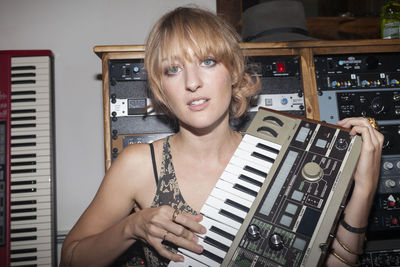 Young female musician playing a keyboard