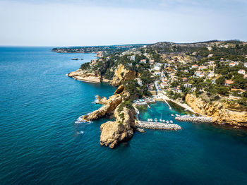 High angle view of sea and city against sky