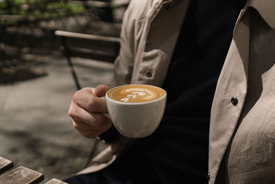Man drinking coffee at outdoor cafe