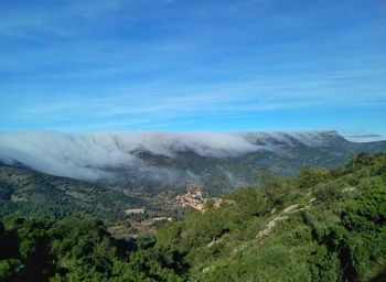 Scenic view of landscape against blue sky