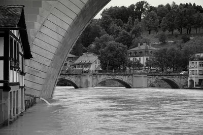 Bridge over river amidst buildings