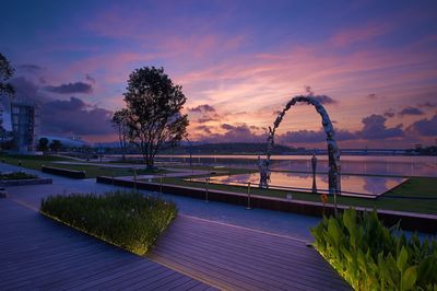 Scenic view of swimming pool against sky during sunset