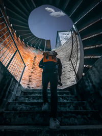 Low angle view of man standing on staircase