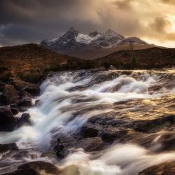 Scenic view of waterfall against sky