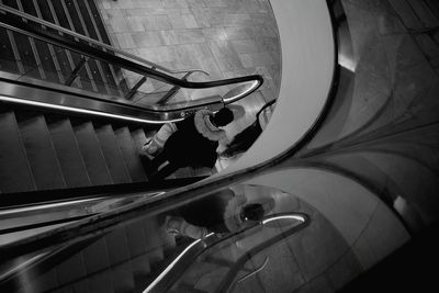 Low angle view of man walking on escalator