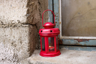 Close-up of red lantern against wall