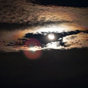 Low angle view of moon against sky at night