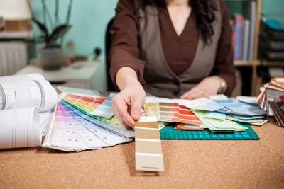 Midsection of woman working on table