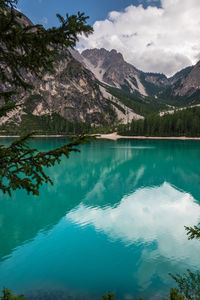 Scenic view of lake by mountains against sky