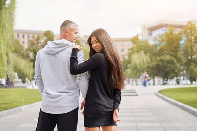 Rear view of couple standing outdoors