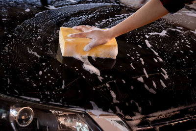 Women cleaning car wash with sponge yellow and foam stronger women cleaning car her concept person