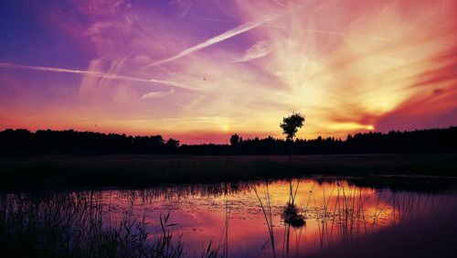 Scenic view of lake against sky at sunset