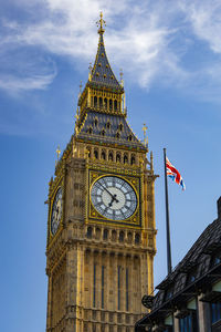 Low angle view of clock tower against sky in city