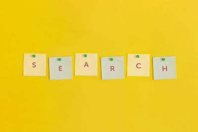 Close-up of toy blocks on yellow background