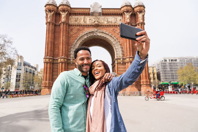 Happy couple taking selfie on road