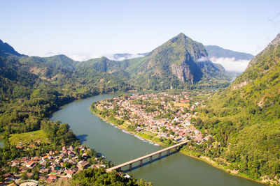 Scenic view of river amidst mountains against sky