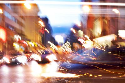 Blurred motion of cars on illuminated city street at night