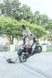 People riding motorcycle on road