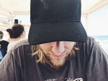 Close-up of bearded man wearing cap