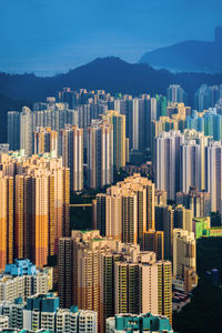 Aerial view of buildings in city against sky