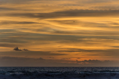 Scenic view of sea against orange sky