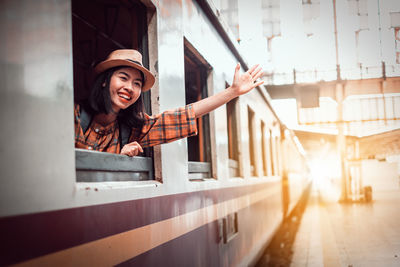Smiling young woman in train