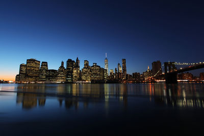 Reflection of illuminated buildings in water at night
