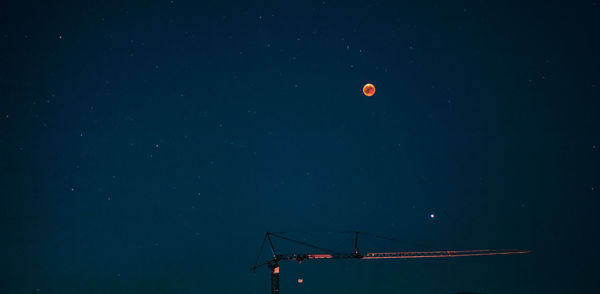 Low angle view of moon against sky at night