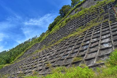 Low angle view of stone wall against sky