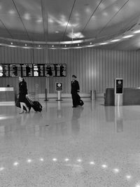 People walking in illuminated airport