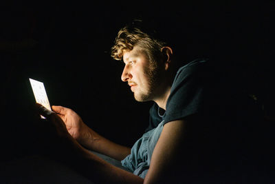 Side view of man using mobile phone