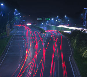 High angle view of light trails on highway at night