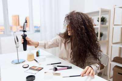 Midsection of woman working on table