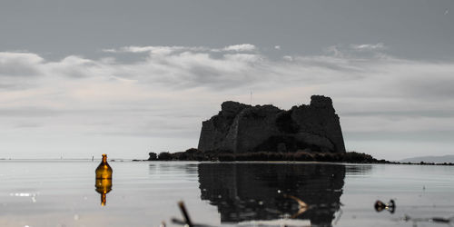 Built structure on sea against sky