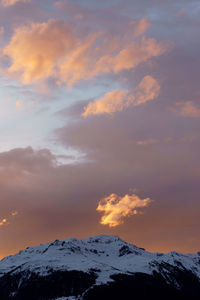 Scenic view of snowcapped mountains against sky during sunset