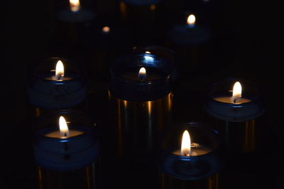 Close-up of illuminated tea light candles in temple