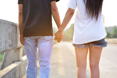 Rear view of friends standing outdoors