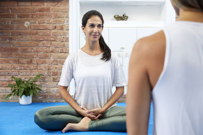 Young woman meditating in a yoga class. self confident