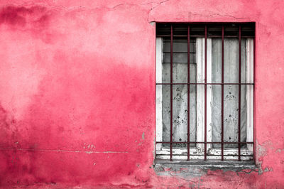 Window on red wall