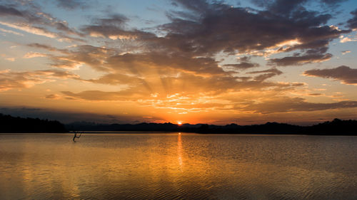 Scenic view of lake against romantic sky at sunset