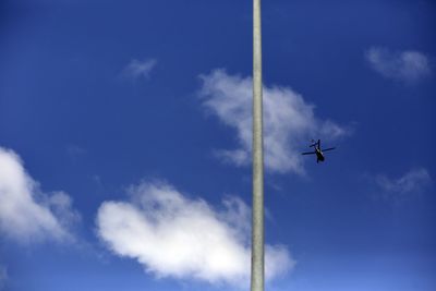 Low angle view of airplane against cloudy sky