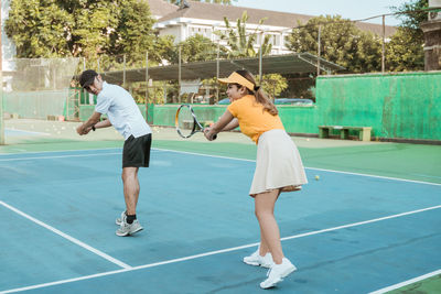 Full length of woman playing tennis