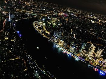 High angle view of illuminated city buildings at night